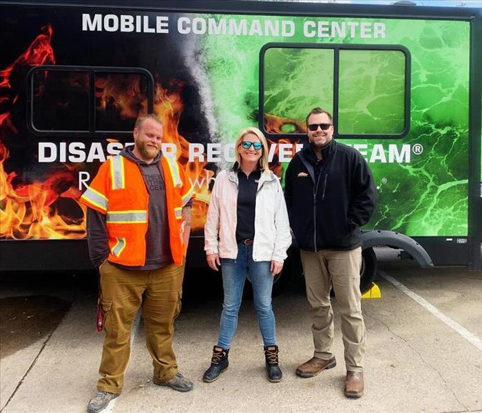 Ethan Ashley and Kory standing in front of the mobile command center